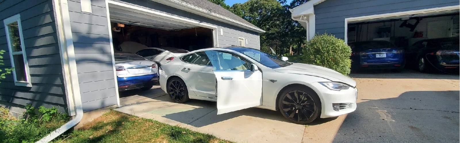 White Tesla parked in a driveway for ADAS calibration service in Wisconsin