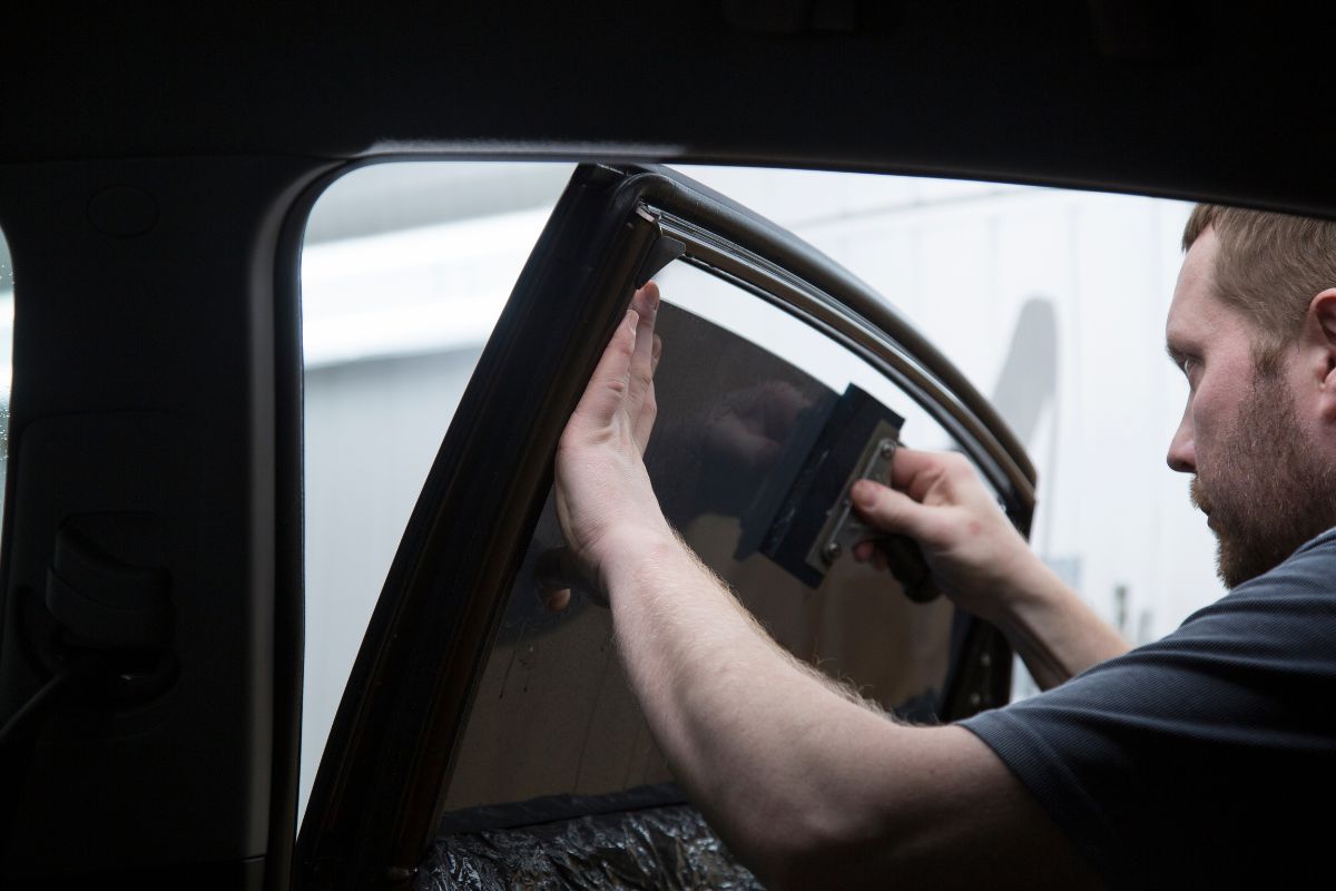 Tinted Car Windows - Affordable Auto Glass Tinted windshield service by Affordable Auto Glass technician applying legal UV-protective tint on a car windshield in Wisconsin.