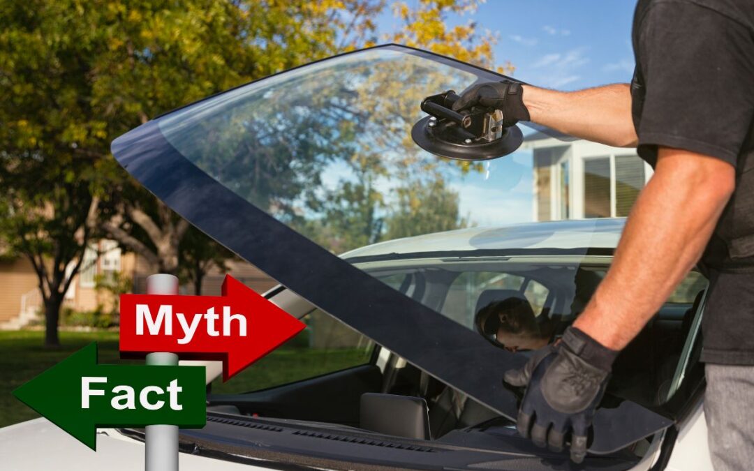 Auto glass technician in Wisconsin repairing a windshield with a sign that reads 'Myth or Fact'