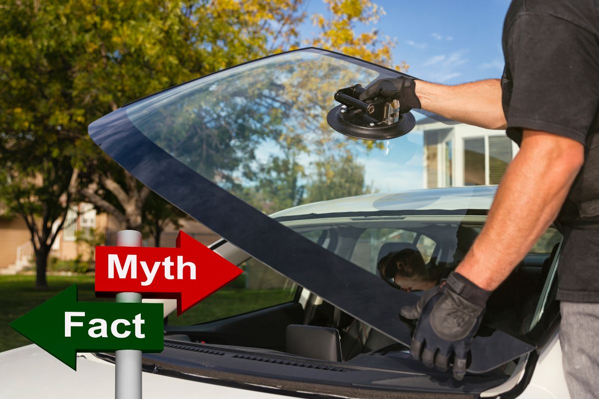 Auto glass technician in Wisconsin repairing a windshield with a sign that reads 'Myth or Fact'