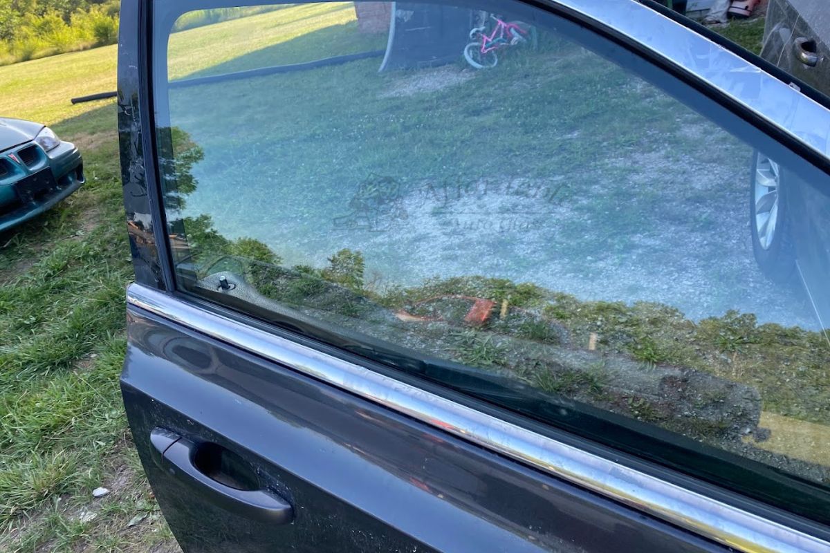 Close-up of a car door with newly replaced side window, showcasing professional car window repair in Milwaukee by Affordable Auto Glass Wisconsin.