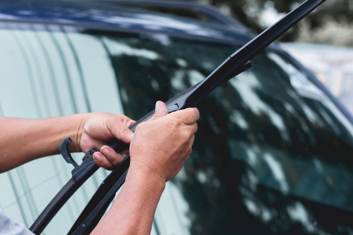 Close-up of new windshield wipers being installed on a freshly replaced windshield in Milwaukee, WI