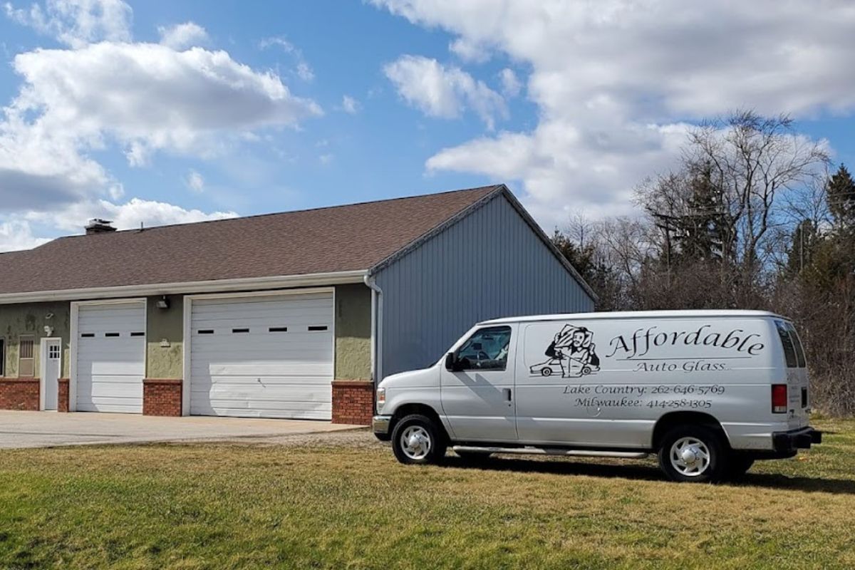 save-money-on-windshield-replacement-wisconsin Affordable Auto Glass van parked outside repair shop in Wisconsin, offering mobile services to help drivers save money on windshield replacement.