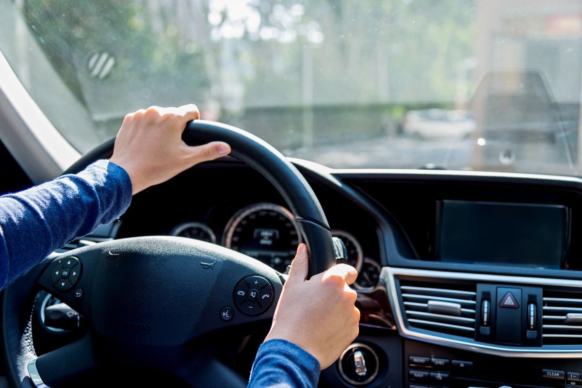Driver hears a whistling sound while driving caused by windshield damage or seal issues.