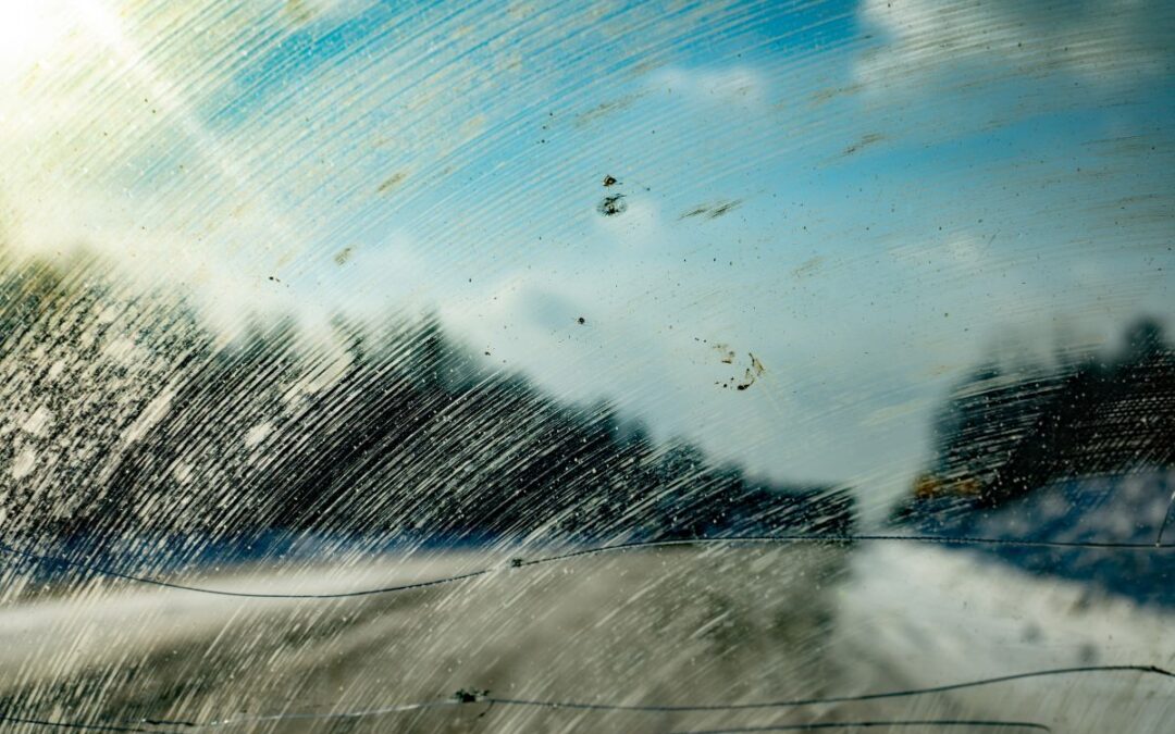 a dirty windshield with a lines of crack