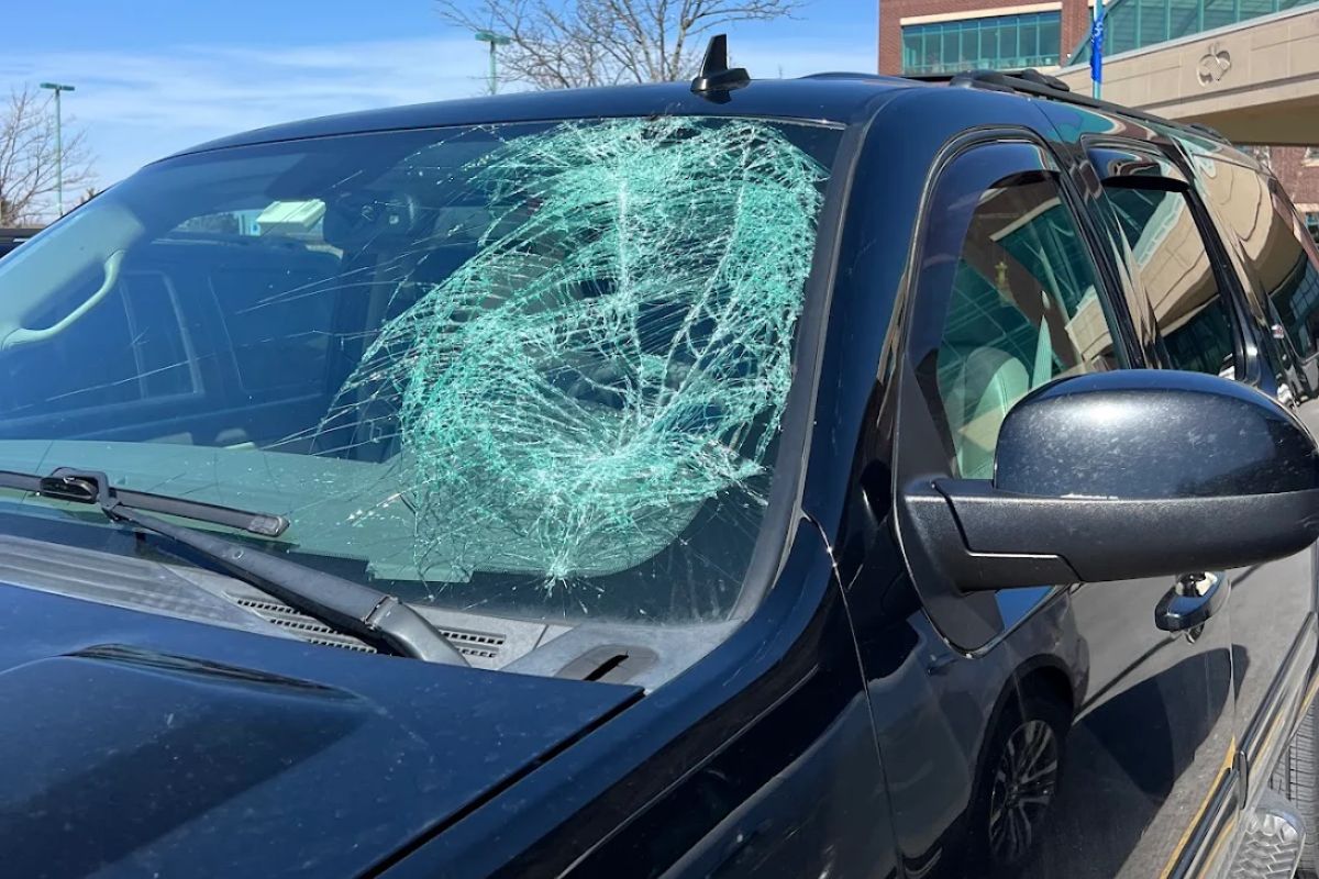 Car windshield with visible crack caused by road debris in Waukesha, Wisconsin.