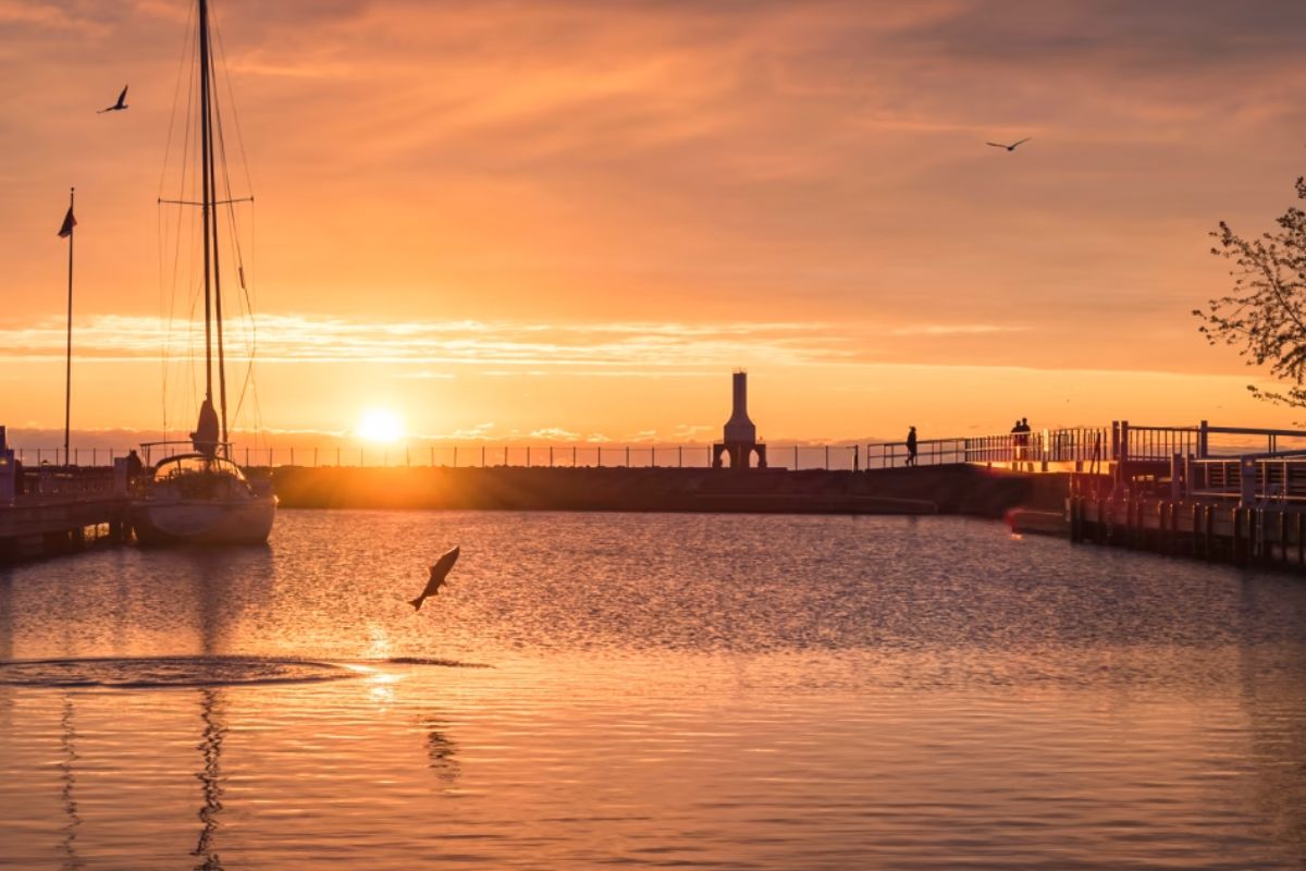 Sunset view over Lake Michigan in Ozaukee County, Wisconsin, symbolizing coastal weather conditions that can affect auto glass due to humidity, salt air, and temperature changes.