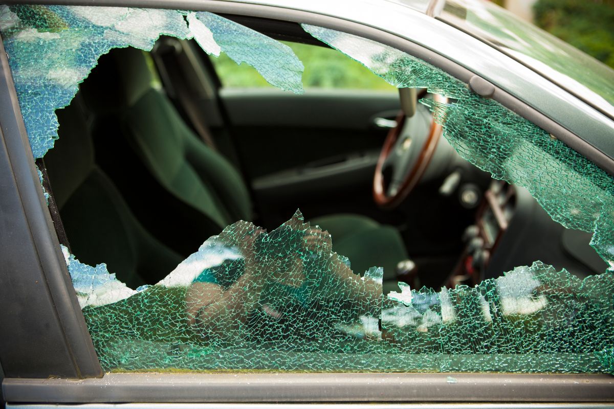 Broken car window with shattered side glass after a break-in, showing interior damage and need for auto glass replacement in Wisconsin